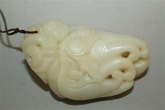 A Chinese white jade carving of a boy clambering on a finger citron, 7.7cm